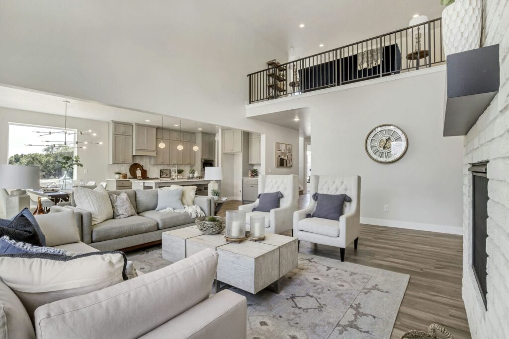 A cozy living room featuring a fireplace and a staircase, showcasing a warm and inviting atmosphere in a house.