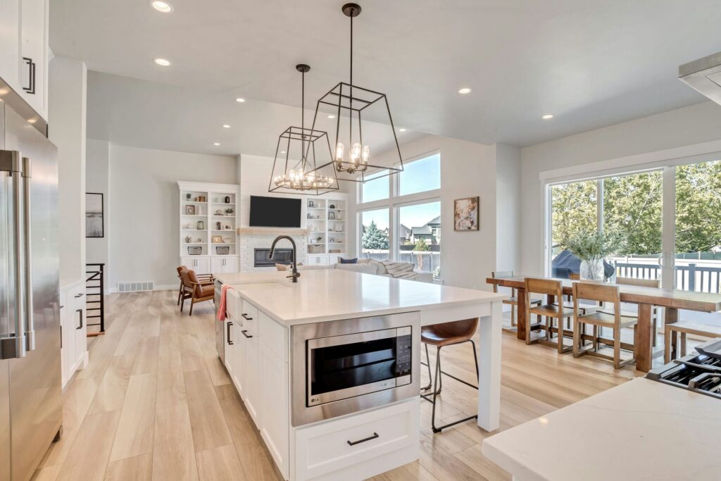 A spacious kitchen with a central island and a dining area, designed by Patterson Homes.