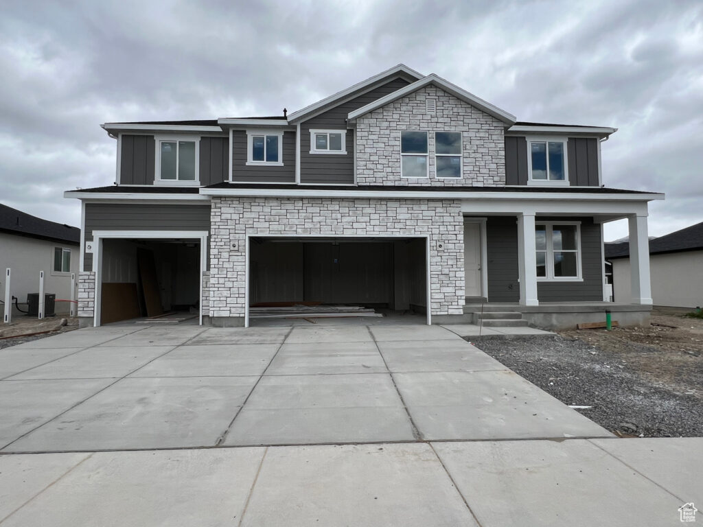 A gray house with a garage and a driveway.