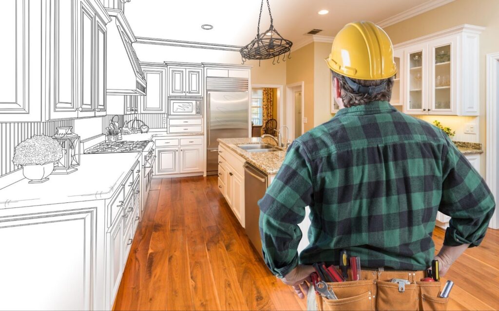 A construction worker wearing a hard hat, examining the kitchen area