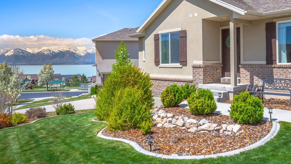 A Utah home with a landscaped lawn and mountain backdrop.