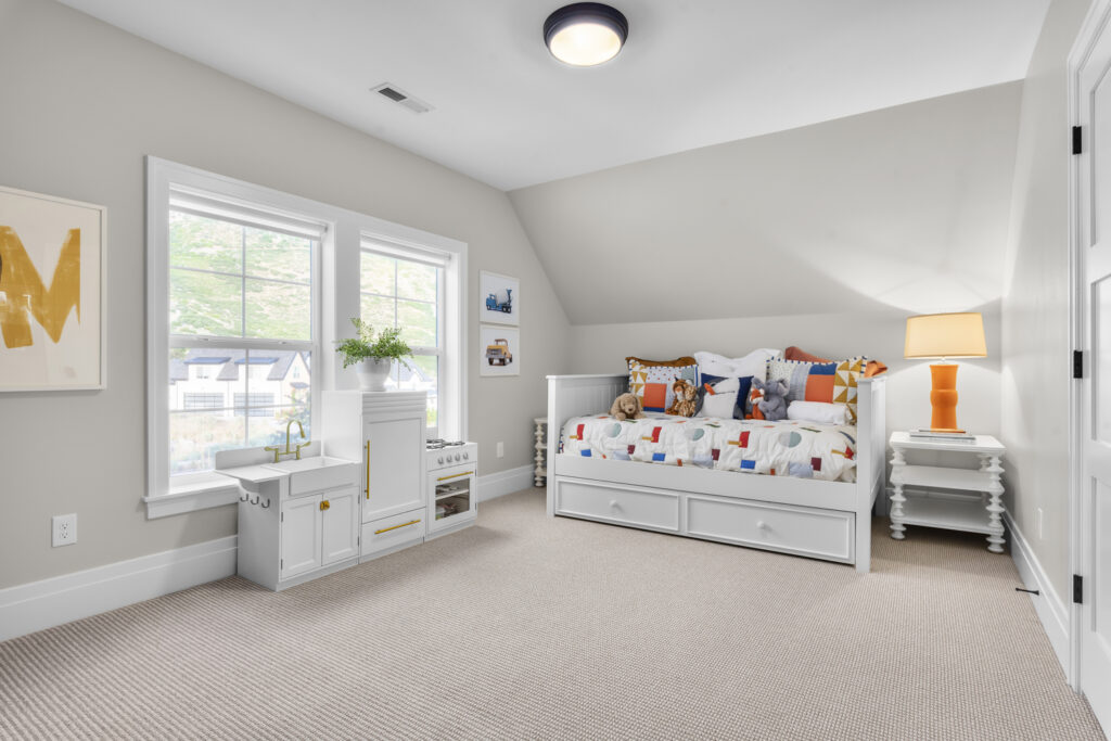 A cozy bedroom featuring a bed, dresser, and window,showcasing a blend of Colonial and Contemporary design elements.