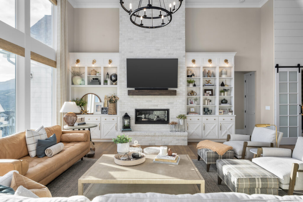 A cozy living room featuring a fireplace, comfortable couches, and a television, designed in a Colonial style.