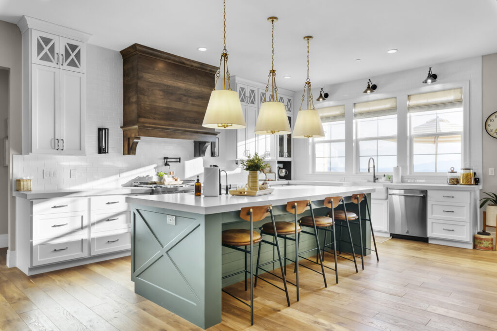 A modern kitchen featuring a center island and elegant wooden floors, showcasing a blend of Colonial and Contemporary design elements.