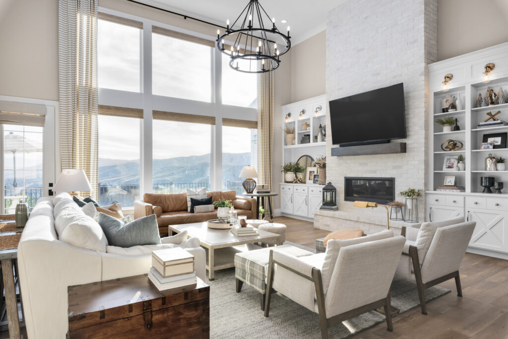 A modern living room featuring a fireplace, comfortable couches, and a television, ideal for quick move-in new builds.