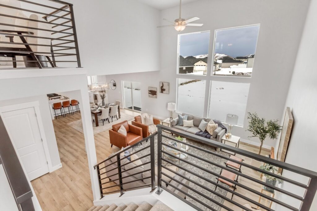 A top view of a modern living room and staircase in a newly constructed home, showcasing quick move-in benefits.