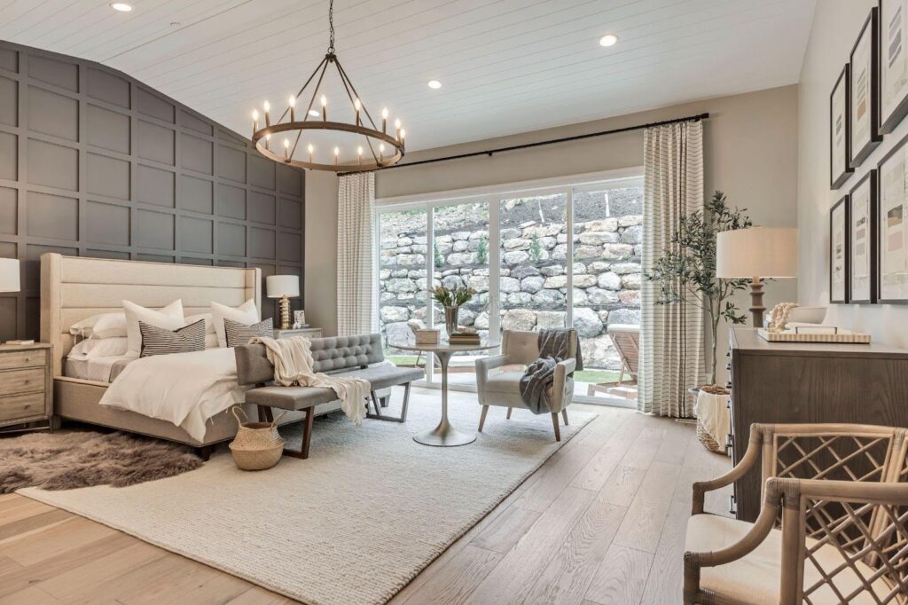 A beautifully designed bedroom with a chandelier and cozy bed, enhancing elegance and comfort