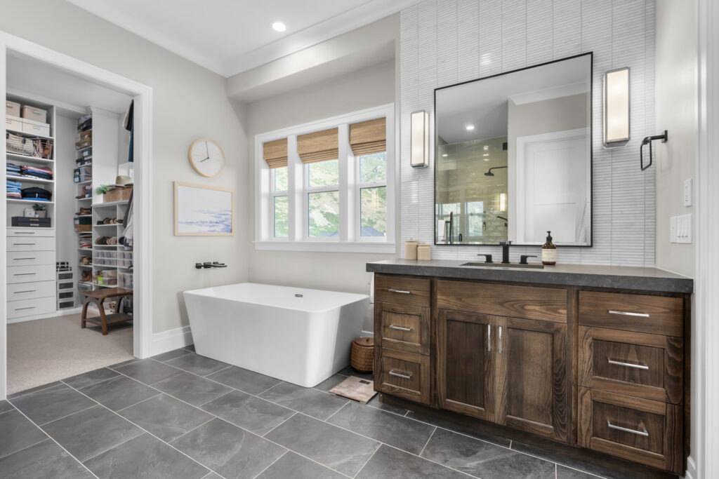 A luxurious bathroom featuring a spacious tub and elegant sink, showcasing exquisite home design and upscale amenities.