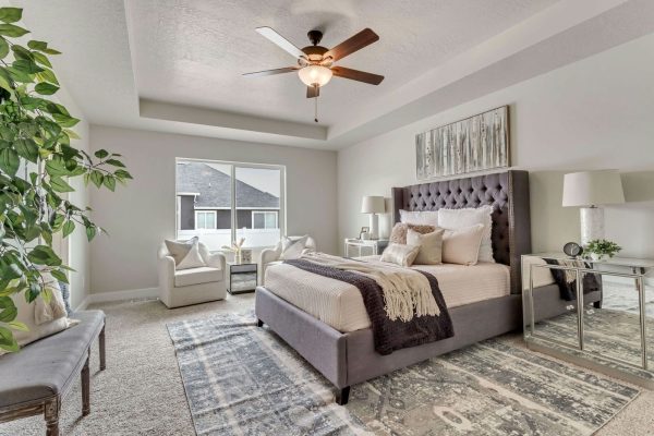 A cozy bedroom with a bed and a ceiling fan providing comfort and relaxation.